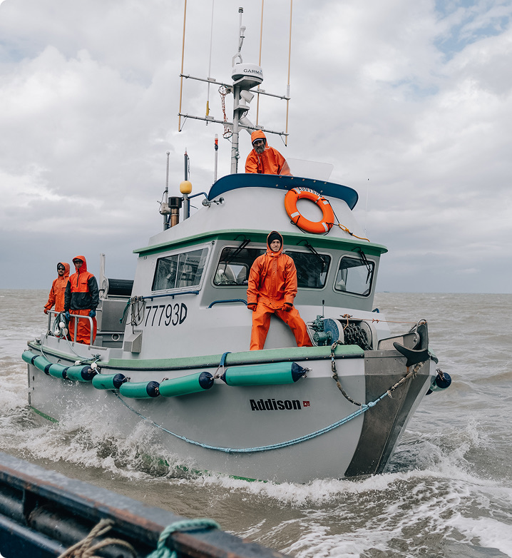 Fishing vessel offloading to tender in Alaska